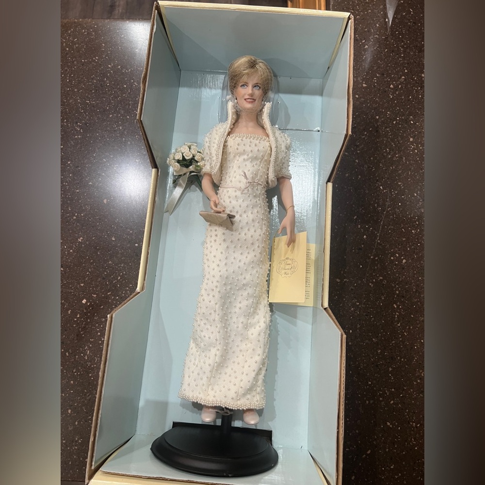 Franklin Mint Princess Diana porcelain doll with accessories in original box.